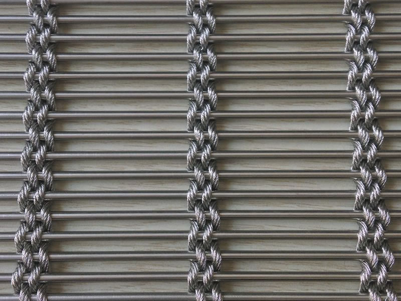 Exterior wall covering mesh drapery