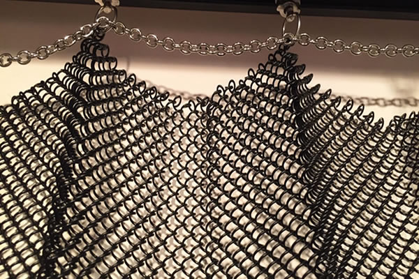 Coiled mesh drapery curtain